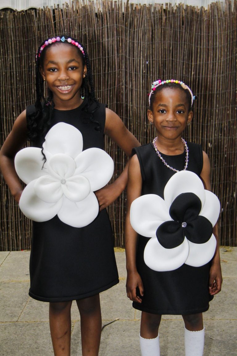 Young girls showing off high fashion dresses